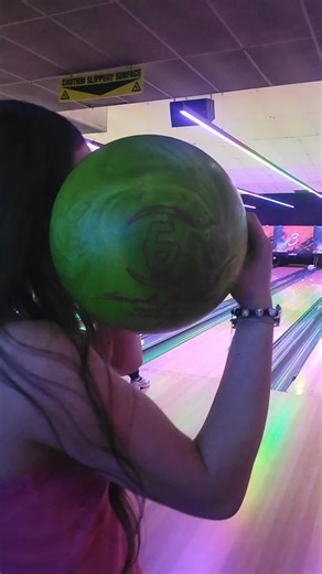 Bowling Fun with Sienna: A Goofy Snapshot