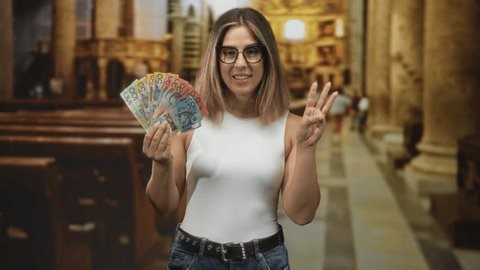 clip-3996084273-woman-holds-fan-australian-banknotes-points-index