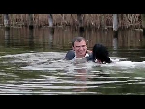 Wetlook A couple goes into water in their wedding clothes