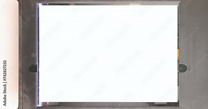 Operation of a flatbed scanner with sheet of paper in open mode. Movement of the head, lamp. Close-up. Top view.