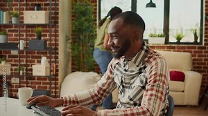 Office employee working on computer at desk, doing remote task at home with girlfriend. Young adult using online web app to plan financial data for company report, sending email.