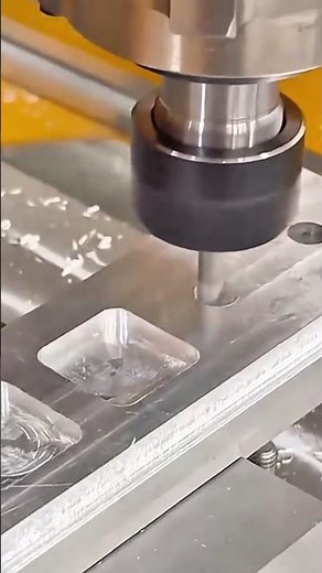 Precision machine cuts metal block using rotating milling tool