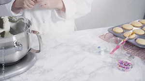 Step by step. Mixing ingredients in kitchen mixer to make buttercream frosting for mermaid theme vanilla cupcakes.