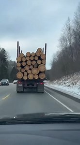 Dashcam footage shows a logging truck taking a sharp turn too fast, load straps failing suddenly, and giant logs tumbling off onto the road behind it. | Funniest Videos On The Internet