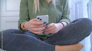 Woman using modern mobile phone for online communication. White female browsing internet on cellphone in closeup footage. Person communicating on social media app with new smartphone in 4k stock video