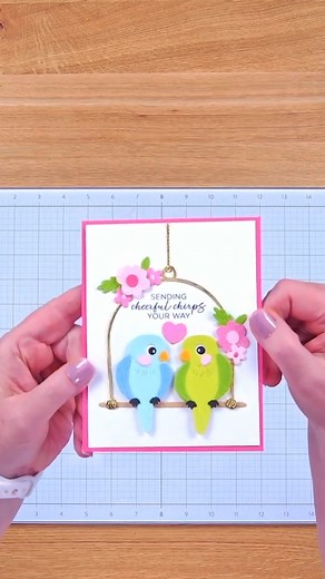Two little lovebirds, one adorable card! 🦜 Watch this project come to life using the Pretty Birds Etched Dies Spread Your Wings Sentiments Clear Stamp Set from the Cheerful Chirps Collection! 💗✨ Shop the collection → https://spellbinders.shop/3SSV5BS #cardmaking #shakercard #tropicalcards | Spellbinders Paper Arts