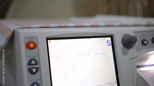 Electrocardiogram monitoring which is using to monitor heart pulse of a patient (Focus at heart rate number). Healthcare and medical, 4K footage with hand holding.