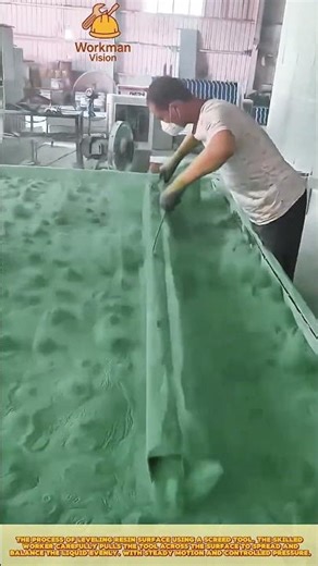 Skilled Worker Leveling Resin Surface Using Screed Tool for Smooth Epoxy Finishing
