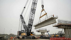 The Liebherr LR 13000 lifts heavy concrete sections for a bridge installation. | Wow Things | Facebook