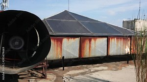 Rooftop of industrial building with heating ventilating and air conditioning units. Industrial exhaust at rooftop of building