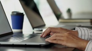 4k video of hands of men who typing laptop keyboard sitting at desk and working at laptop computer at home with laptop