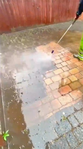 cleaning dirty brick pavement with a high pressure water sprayer #shorts