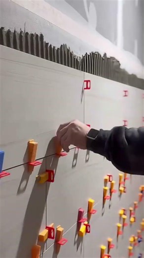 installing rectangular white ceramic tiles on the walls of a room in a building is easy and fast.