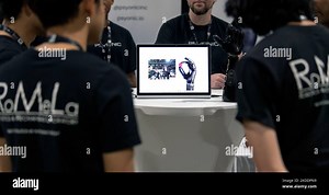 Long Beach, California, USA. 04th Nov, 2022. A robotics team from UCLA checks out a video presentation and robotic arm and hand from Psyonic in the pit area as 17 international teams of roboticists from 10 countries compete for the $8 million ANA AVATAR XPRIZE at the Long Beach Convention Center. The competition, the culmination of a four-year process which began of March of 2018, challenges teams to develop physical, human-operated robotic avatar systems that can execute tasks and replicate a h