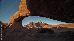 The Bridge, a natural arch formation in Spitzkoppe Namibia Southern Africa - Morning to dusk timelapse