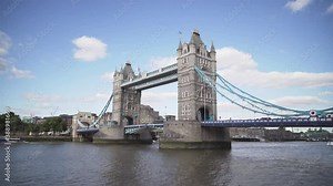 Plane flying over Iconic Tower Bridge in London full of people and cars, wide angle view, sunny day Stock Video