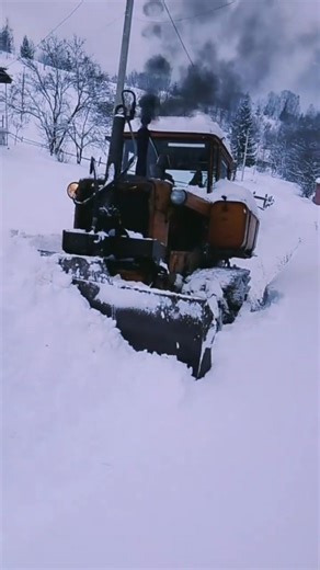 The antique bulldozer cleared 2 meters of snow.
