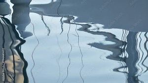 Distorted reflection of sailing boats and yachts on sea water surface