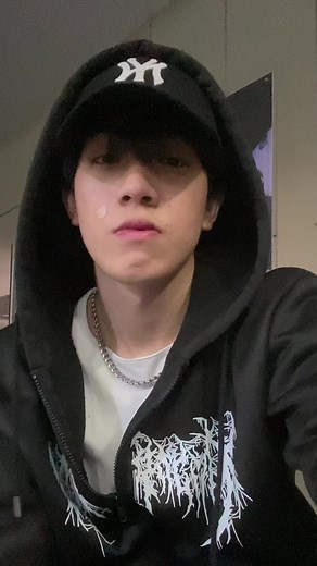 Trendy Black Hoodie and Cap Fashion in Indoor Settings