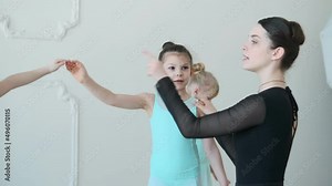 Young girls from ballet dancing ballet in white studio. Pretty graceful ballerinas doing elements of classical ballet - arts concept 4k footage