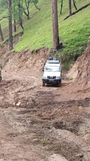 Off-Road Vehicle Struggles Up Muddy Hill
