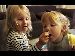 Cute Baby wants to eat popcorn with his sister
