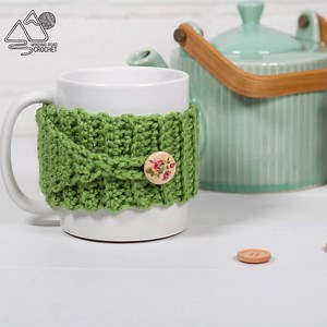 Whip up a quick and easy crochet cup cozy that can fit any cup size. Just move where you place the button. Find the written pattern and material list on the Winding Road Crochet Blog. | Winding Road Crochet