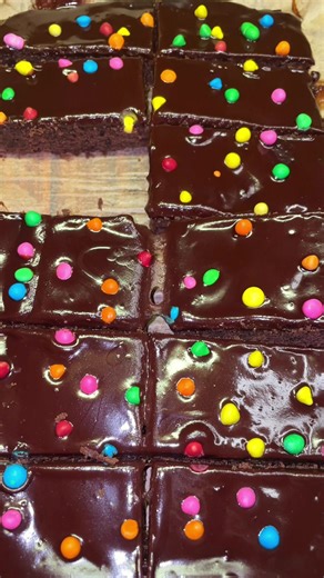 Cosmic Brownies from scratch 🍫✨ Full recipe below 🎉 *Don’t forget to check out our brand new cookbook in our bio for more delicious recipes 🫶 Recipe: Ingredients for Brownies: ½ cup unsalted butter ¾ cup granulated sugar ¼ cup brown sugar ½ cup cocoa powder ¼ tsp salt 1 tsp vanilla extract 2 large eggs (room temp) ½ cup all-purpose flour 1 tbsp cornstarch Ganache Topping: ¼ cup heavy cream 4 oz semisweet chocolate chips Pinch of salt Sprinkles: 2-3 Tbsp rainbow candy-coated chocolate chips In