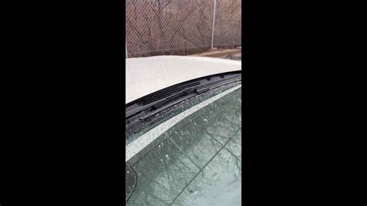 Sleet slowly accumulates on a car hood in Dunmore, Pennsylvania, USA