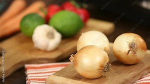 Cooking Ingredients Rack Focus. a close up racking focus shot of carrots lemons, pepper, garlic and onions on cutting boards