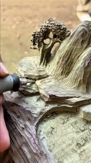 carving detailed mountain and tree scenery on wood block using electric rotary tool for art project