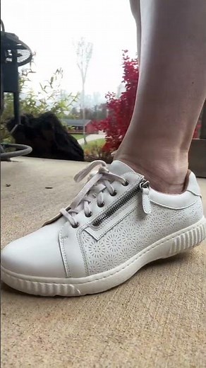 Clarks embossed leather sneakers with a side zipper for easy on/off, cushioned insole, and buttery