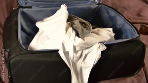 Woman Packing Luggage In A Hurry, Throwing Clothes In It, Messy Packing