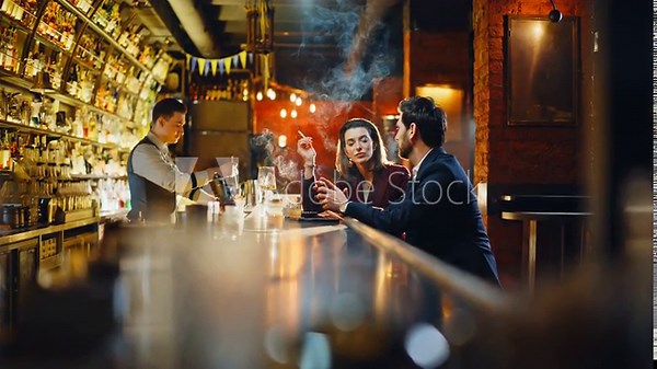 Man offering cigarette flame from matches stylish lady. Elegant couple smoking