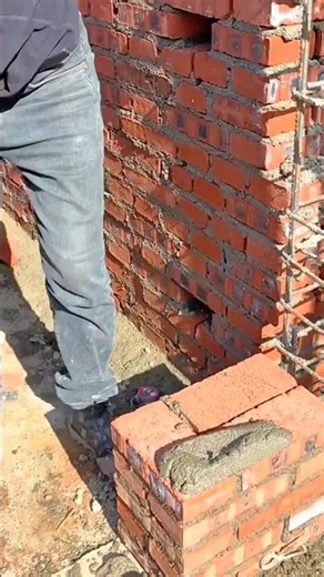 Worker splitting a large tree log with a wedge and hammer in a misty forest setting
