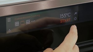 Oven electronic board close-up. View of finger pushing buttons on a cooking stove. Stove time adjustment. Touch panel of a modern electric oven. Modern oven with touch panel, close-up. Cooking program