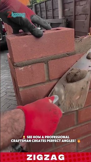 Laying a corner brick and cleanly striking off excess mortar with a trowel