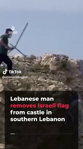 A Lebanese man who returned to his village in southern Lebanon after the temporary ceasefire was announced removes the Israeli flag from Beaufort Castle (Qalaat al-Shaqif). The castle which dates back to the 12th century is in the Nabatiyeh Governorate.
