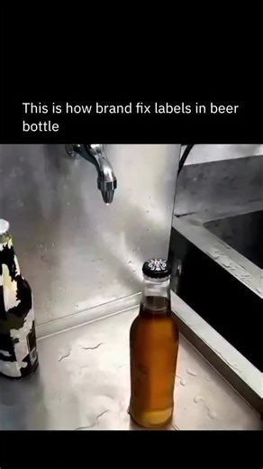 Uncut USA on Instagram: "This clip shows the automated labeling stage of beer bottling, where filled bottles move at high speed through precision rollers and adhesive applicators. Each label is positioned to the exact millimeter and pressed firmly onto the glass in a fraction of a second. The system relies on synchronized motion control, pressure calibration, and optical alignment to maintain uniform placement across thousands of units per hour. Consistency at this scale is critical for branding