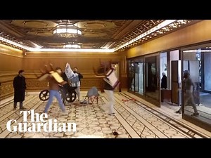 Syrian rebels carry furniture from presidential palace after Assad flees the country