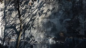 A vibrant fire hydrant stands next to a tree, enhancing the urban landscape beside a building. scene captures the harmony of nature and city life.