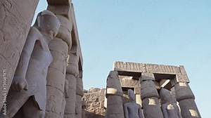 Majestic columns with ancient Egyptian drawings, sun comes out from behind the column. luxor Temple in Luxor, Egypt