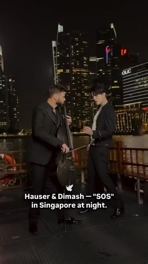 🤗 Stepan Hauser's fan page on Instagram: "Sometimes music ceases to be mere art. It becomes a prayer—pure, all-encompassing, timeless. The performance of "SOS" by Hauser and Dimash is precisely such a case. Against the backdrop of a lit-up Singapore, under the endless dome of the night sky, the energy of a prayer addressed to the sky and embodied in sound is born, erasing boundaries: Dimash's voice is a piercing question, directed upward. It doesn't simply resonate; it pierces infinity, express