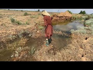 alice with hunterboots in deep mudpit