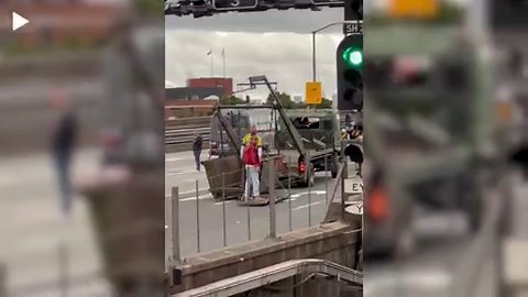 Ryan Gosling waves to fans as he films for upcoming action film