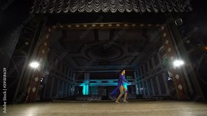 Young skillful ballerinas dancing modern ballet on the stage of large hall. Girls looking at auditorium. Dress rehearsal before performance.