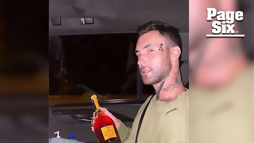 Adam Levine debuts new rose face tattoo, says it's fake