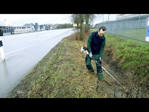 Kustorez Mowing grass on a small slope with a Stihl trimmer line