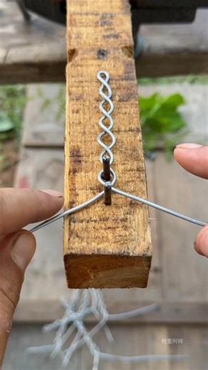Using a nail to bend two wires