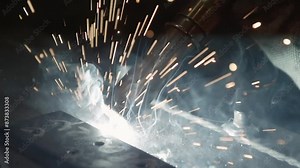 Modern production line at the factory. Automated Industrial welding machine welds steel at production line. Laser. Factory Production. Industrial welder works in slow motion. Close up.